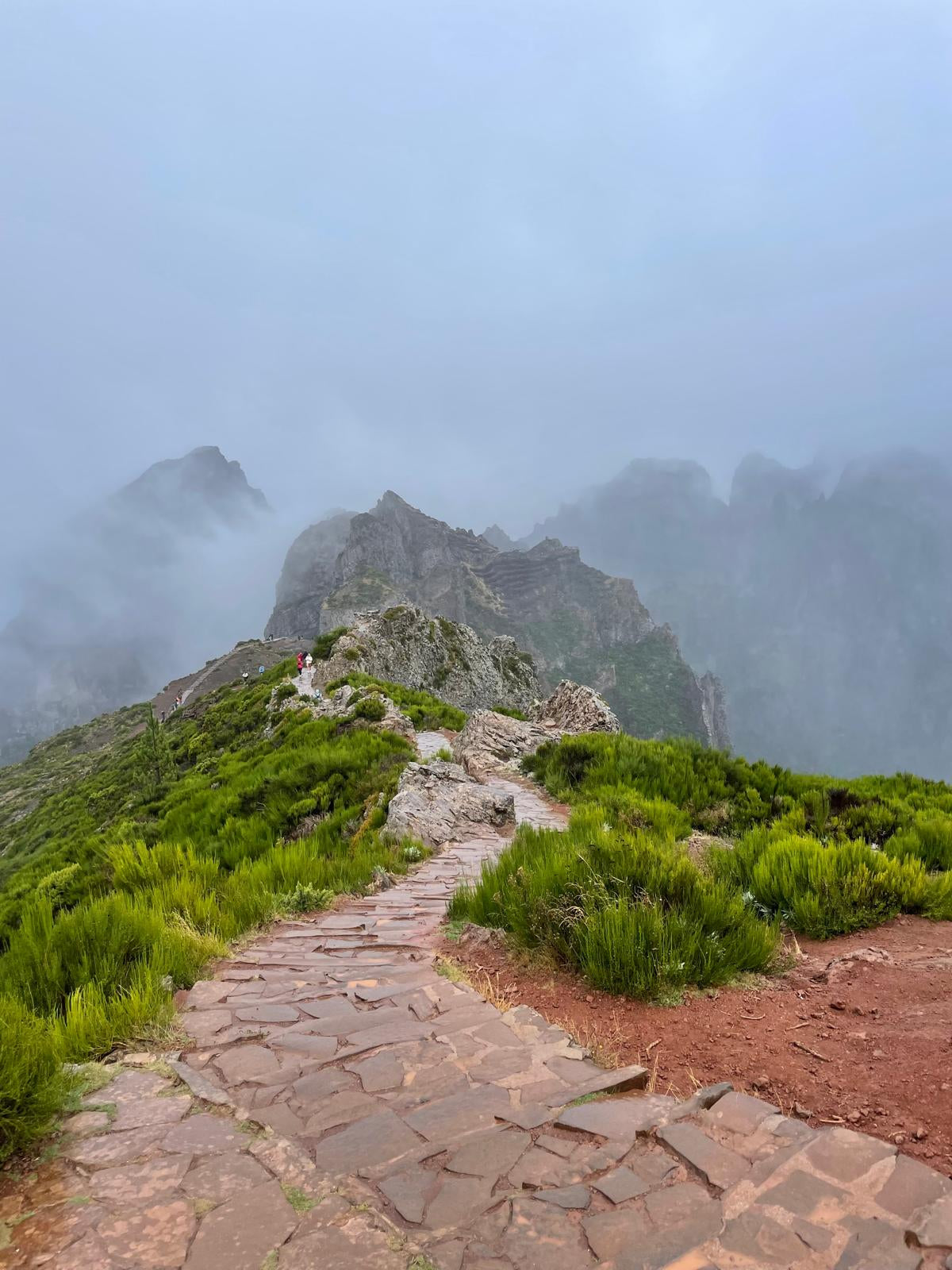 Stony path leading up a mountain with foggy background