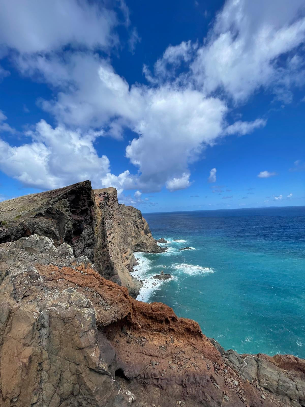 Rocks by the ocean with a clear blue sky