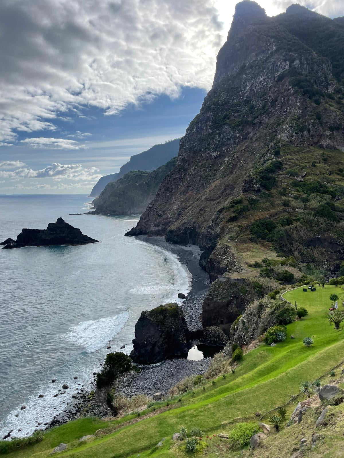 Scenic view of a coastal landscape with cliffs and ocean.