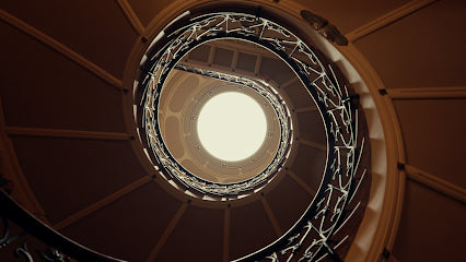 Spiral staircase with a light at the top in a circular view