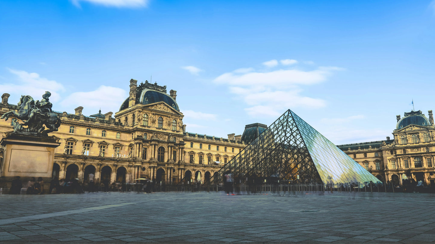 The Louvre Museum with its glass pyramid in Paris, France.