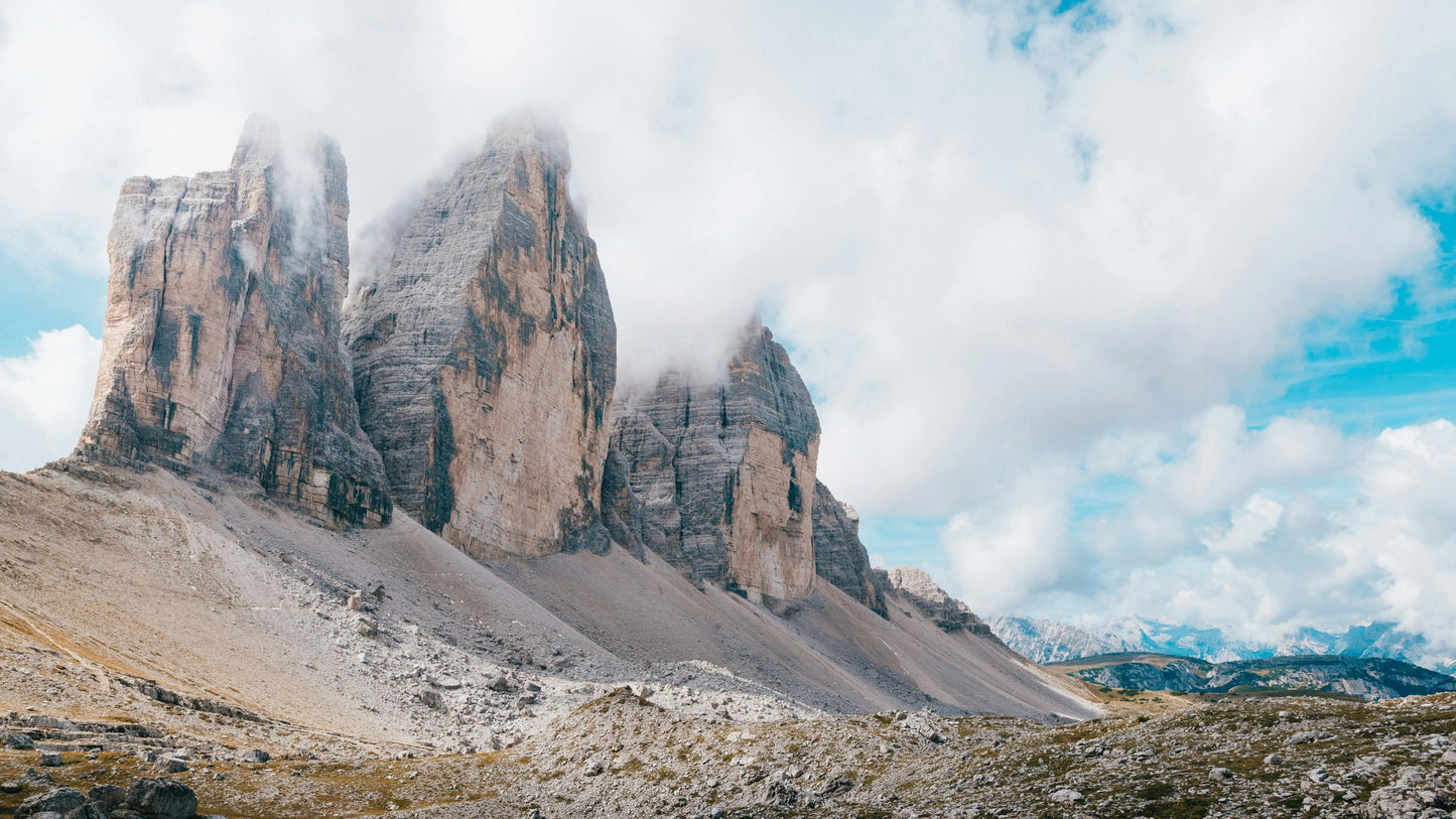 Rugged mountain peaks with clouds and a blue sky