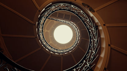 Spiral staircase with a light at the top in a circular view