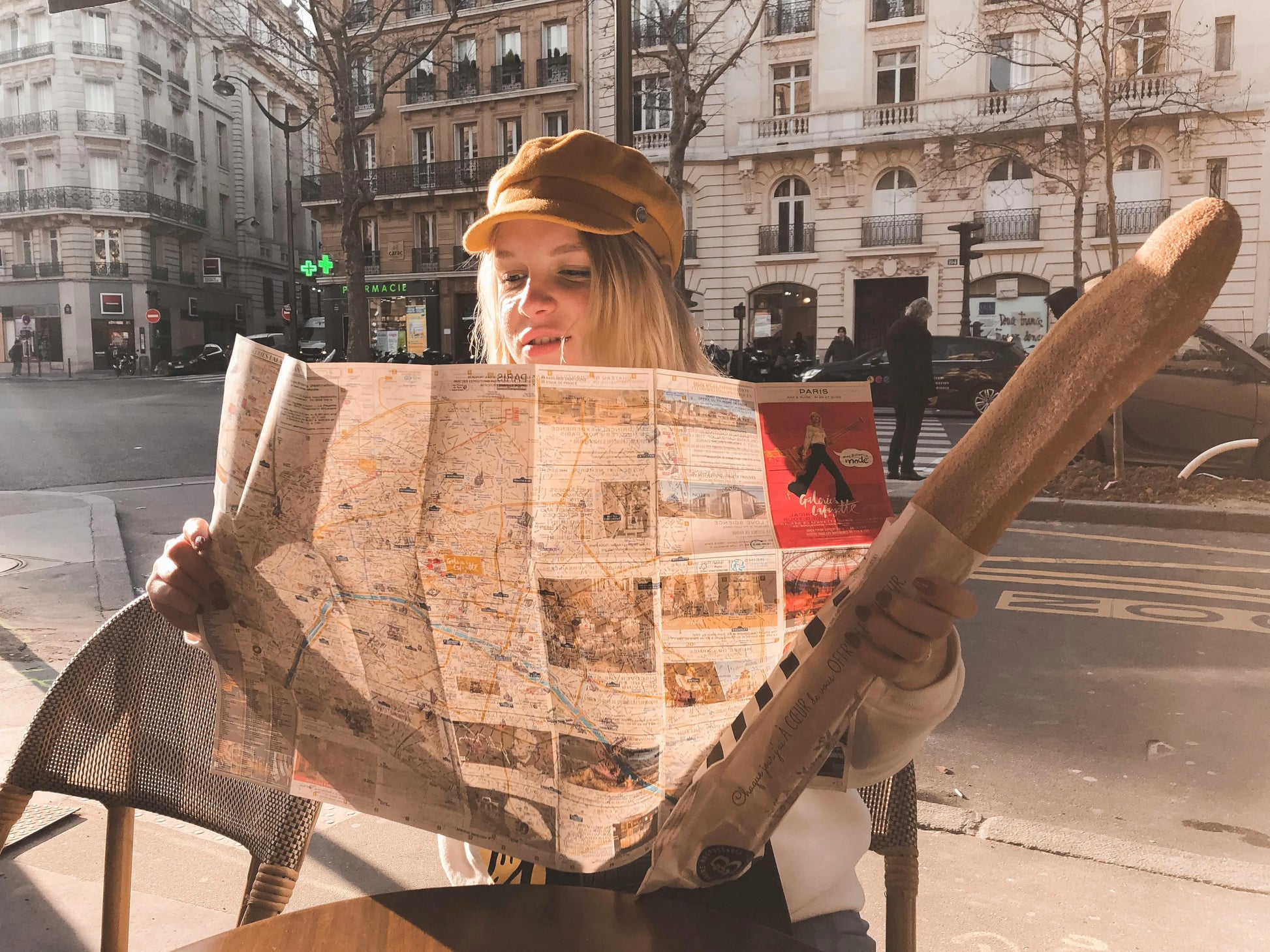 Person holding a map and walking on a city street