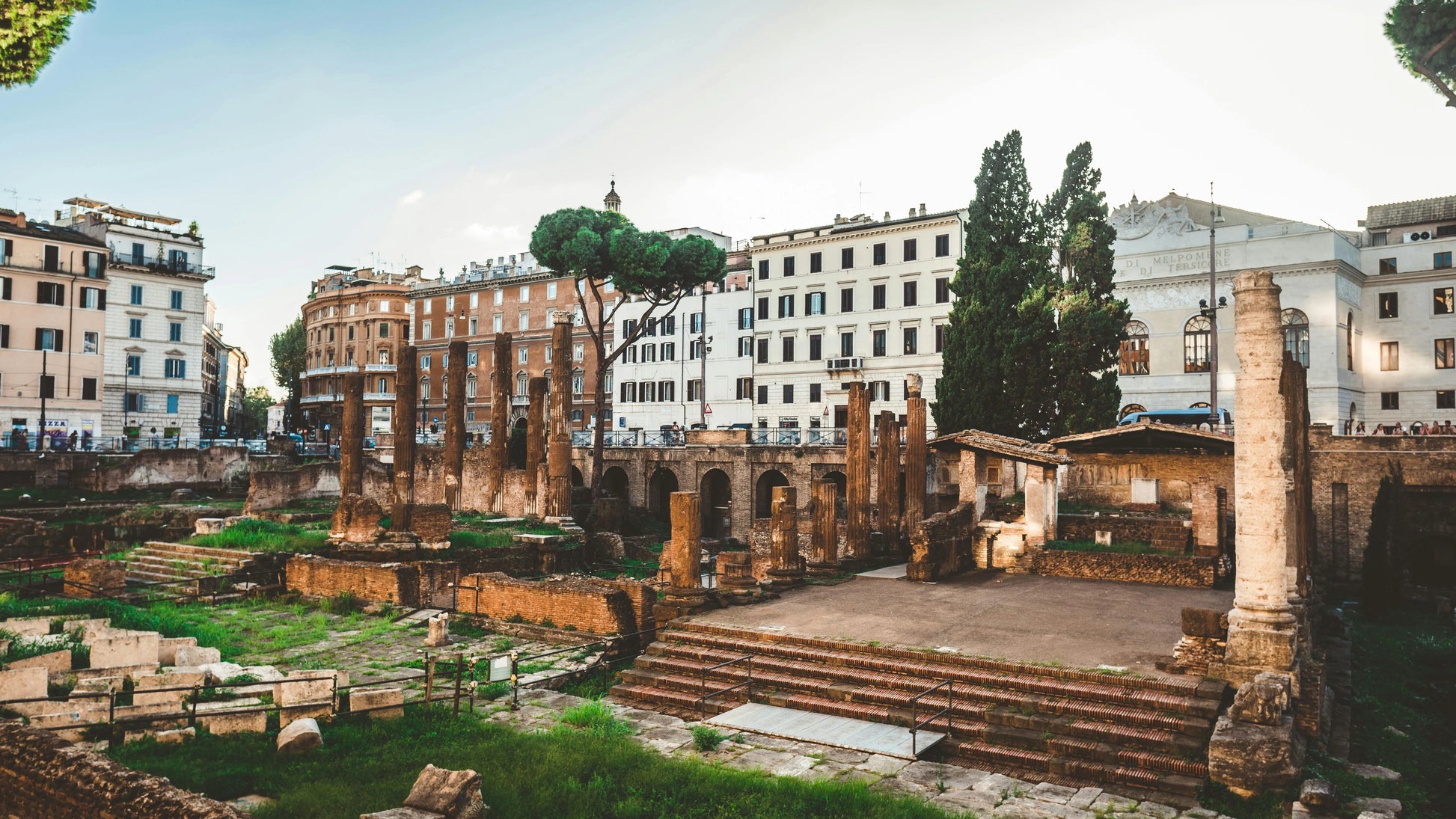 Ancient ruins with modern buildings in the background