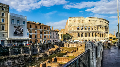 Colosseum in Rome with modern buildings and street in the foreground