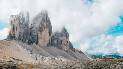 Rugged mountain peaks with clouds and a blue sky