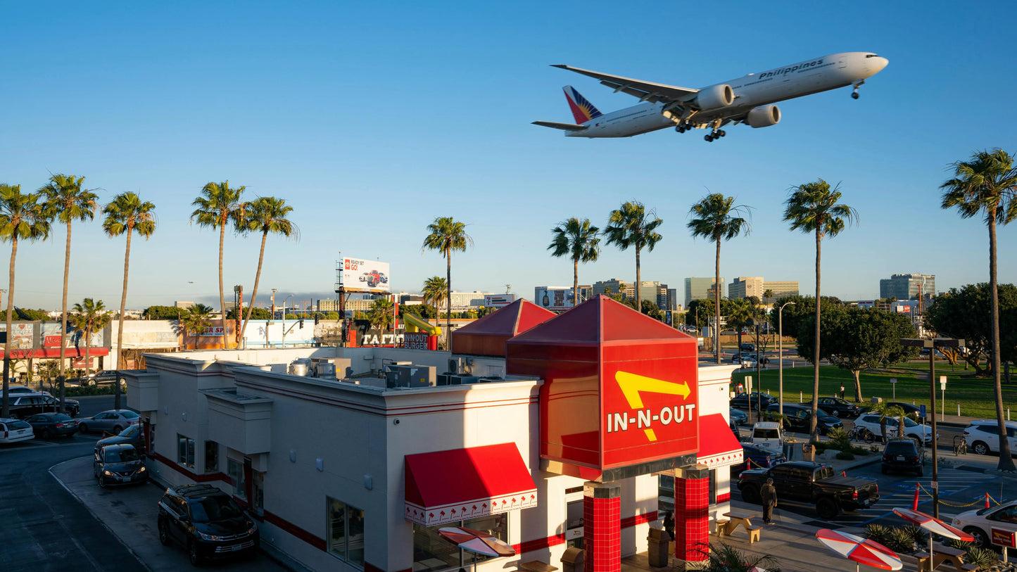 In-N-Out burger restaurant with an airplane flying overhead
